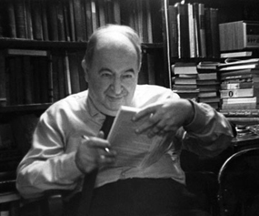 Eli Siegel in his library signing his book of poems Hail, American Development